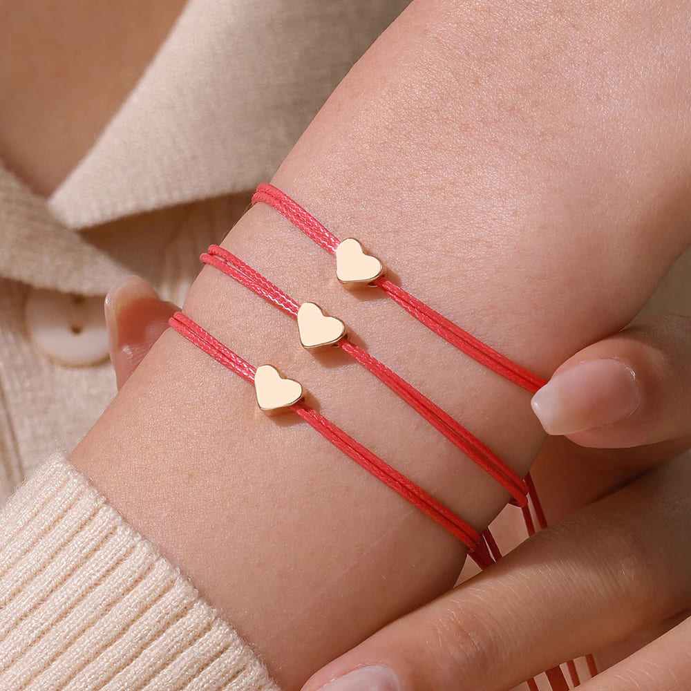 Set of 3 red string friendship bracelets with small gold heart charms adjustable sliding knot