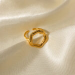Gold ring with an organic irregular circle shape made of surgical steel