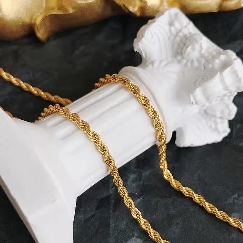 Detailed view of the texture of a twisted gold chain resembling a rope
